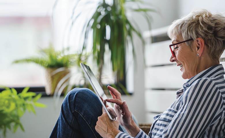 Image of a person using a mobile device to book specialized transit